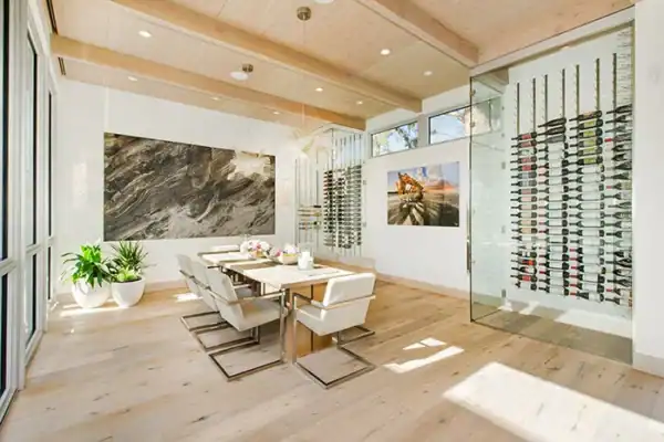 open dining area of modern home with wood floors and glass wine rack ONE Residential Builders Denver