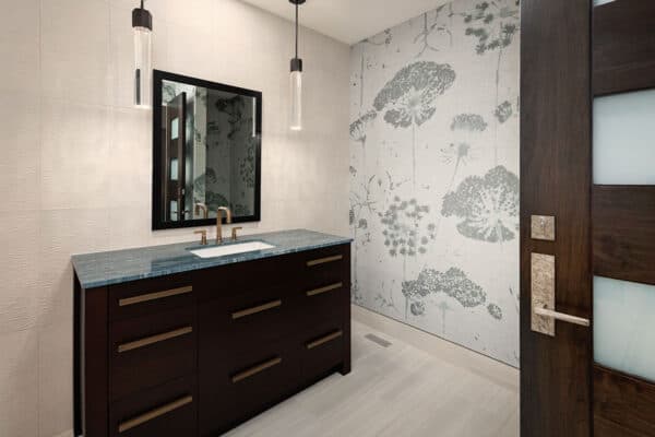 guest bathroom's contemporary touches include blue-gray countertop, copper colored fixtures and drop lighting ONE Residential Builders Denver