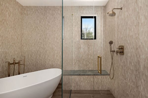 contemporary bathroom highlights include copper color fixtures, large tub, and seat in shower ONE Residential Builders Denver