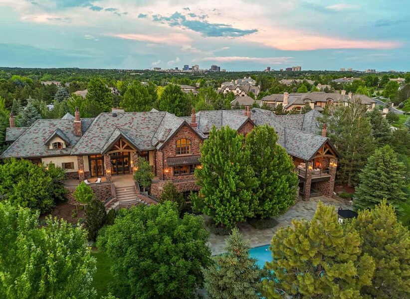 aerial view of front of large, new home with mature landscaping and wide, inviting entryway ONE Residential Builders Denver