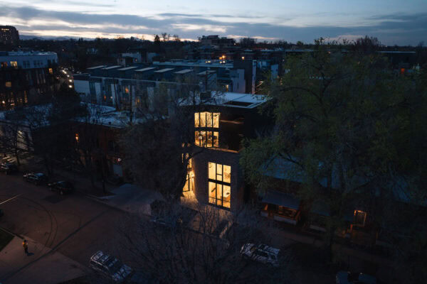 view from across the street of contemporary Denver home with large windows during the evening ONE Residential Builders Denver