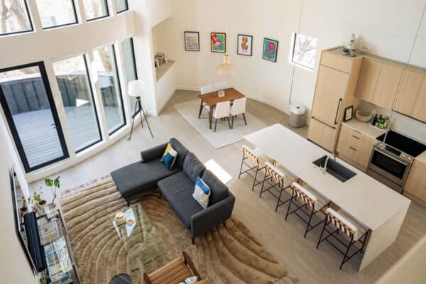 open concept first floor view from upstairs cozy dining area, family area, and kitchen with island ONE Residential Builders Denver