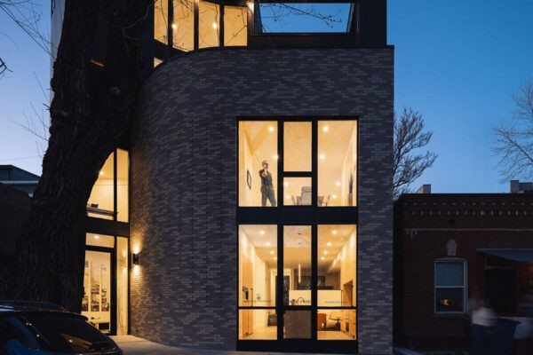 modern home combines metal siding, brick, and large windows ONE Residential Builders Denver