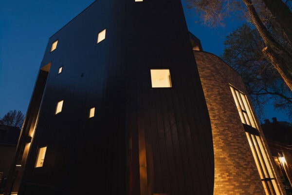 contemporary home at night highlights several small windows on one side of home ONE Residential Builders Denver