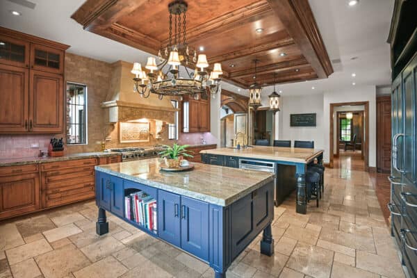extra large kitchen in new home with dual islands, marble vent hood, and coffered ceiling ONE Residential Builders Denver