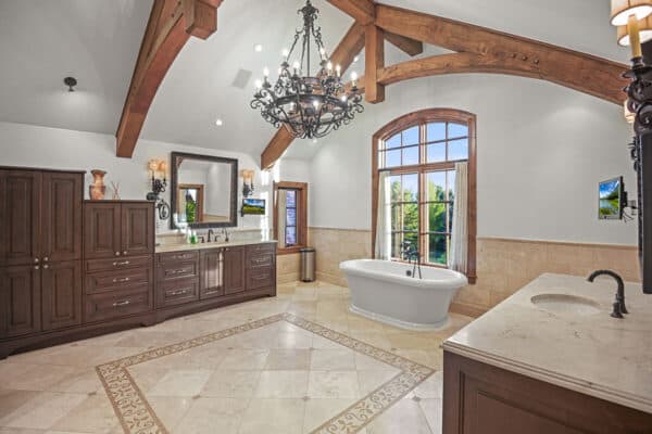 bathroom with Colorado flair with a lot of cabinet storage, opposite side sinks and large soaking tub ONE Residential Builders Denver