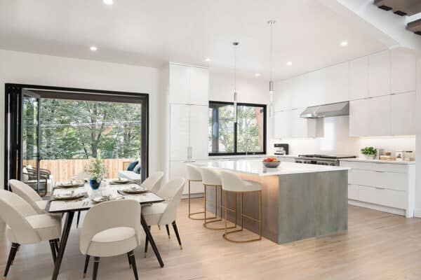 modern cabinets, chairs, nano doors, and large island highlight this home by ONE Residential Builders Denver