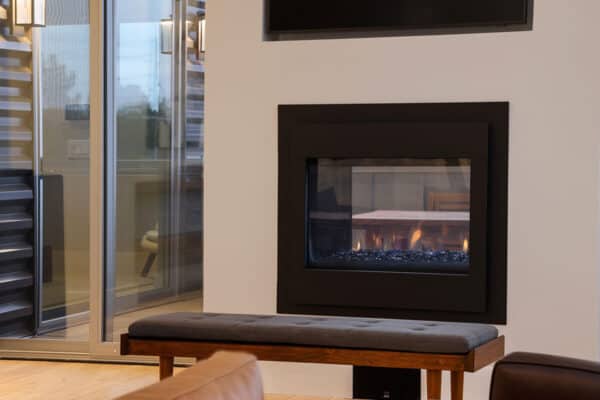 gas fire place with glass pieces and flat screen TV above in contemporary sitting area ONE Residential Builders Denver