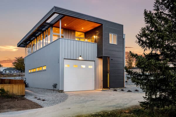 side view of modern home with metal siding and long tandem garage ONE Residential Builders Denver