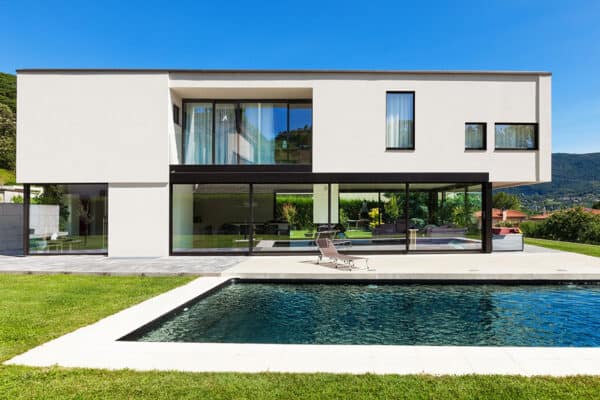mid century inspired new home with clean lines, floor to ceiling windows, and large pool in backyard ONE Residential Builders Denver